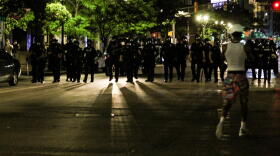 Police march on the gathering at Delaware and Market streets in downtown Indianapolis, blocking traffic. Shortly after, they deployed tear gas, flares and pepper spray pellets at protesters.