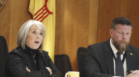 New Mexico Gov. Michelle Lujan Grisham, left, and Senior Public Safety Advisor Ben Baker, right, provide an update, Monday, Dec. 11, 2023, in Santa Fe, New Mexico, on a public health order aimed at reining in gun violence and drugs in the Albuquerque area that the governor describes as an epidemic. New Mexico could become an early political testing ground for a proposal to make assault-style weapons less deadly.