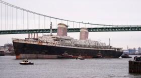 FILE - The SS United States is towed down the Delaware River between Pennsylvania and New Jersey, from Philadelphia, Wednesday, Feb. 19, 2025. (AP Photo/Matt Rourke, File)