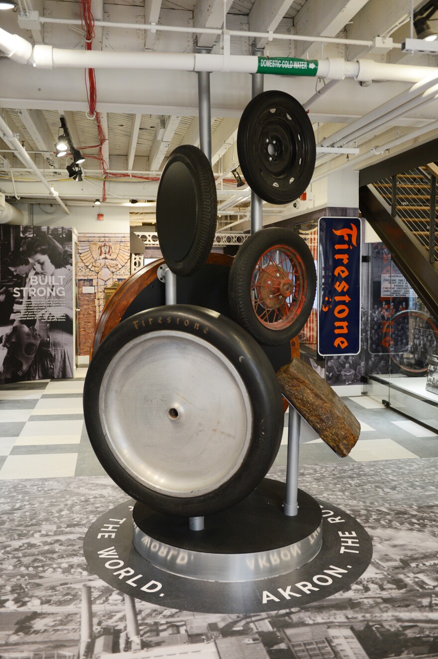 A display of several historic tires stacked on top of one another in a museum