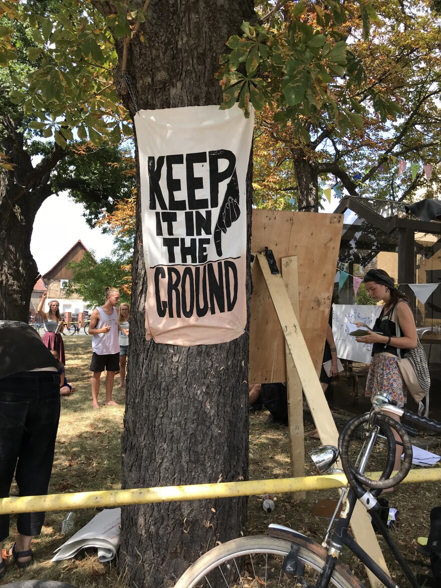 Protesters hang signs against extracting brown coal in the village of Pödelwitz.
