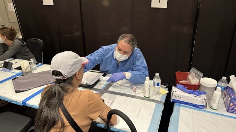 Alika Maunakea, center, professor at John A. Burns School of Medicine, takes medical data from residents affected by the Maui wildfires.