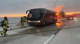 Some 30 people escape injury in bus fire.
