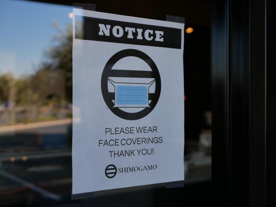 sign on door requests people wear face coverings