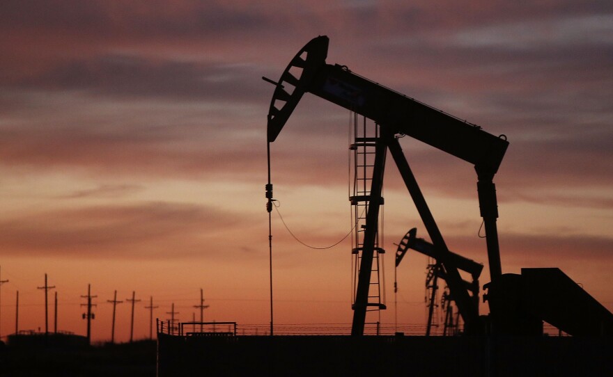 An oil pumpjack works at dawn Jan. 20 in the oil town of Andrews, Texas.