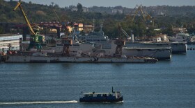 A ferry boat navigates across Havana Bay as it passes Cuban coast guard ships docked at the port as it leaves Casablanca, Cuba, Thursday, Feb. 26, 2026.