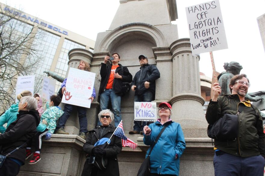 Protestors stand outside the Indiana Statehouse on Saturday, April 5 protesting against President Trump and his policies. The protest drew hundreds to Indianapolis, and thousands throughout the U.S. (Farrah Anderson / WFYI)