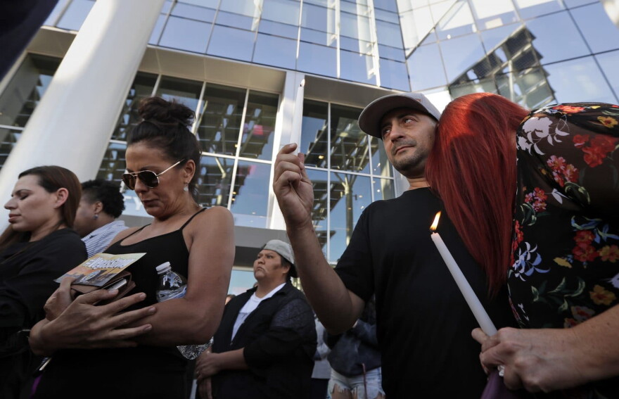 Joe Thomas hugs Elizabeth Reitz, right, during a vigil at City Hall in Las Vegas, Monday, Oct. 2, 2017. The vigil was held in honor of the over 50 people killed and hundreds injured in a mass shooting at an outdoor music concert late Sunday. (Gregory Bull/AP)