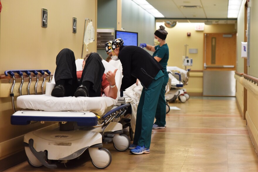 A nurse cares for a patient in the Sparrow Emergency Department