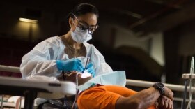 An Army member provides dental work at a community clinic. Such services will be available in Ava, Eminence and Houston for a week, free of charge.