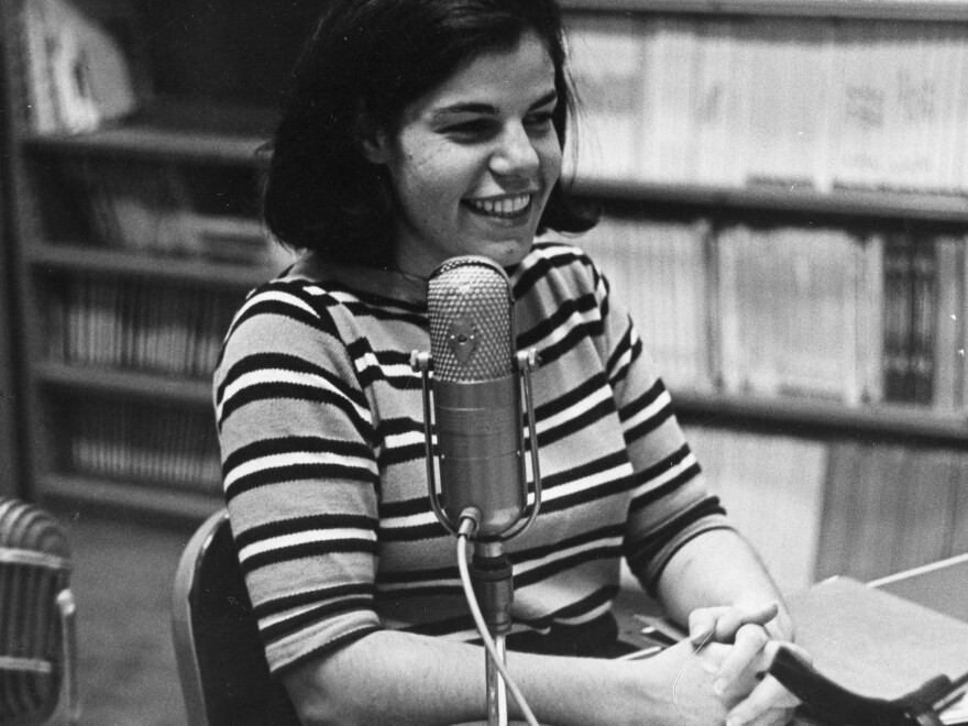 The earliest photo of Susan Stamberg at a microphone, age 25. Later, as the host of <em>All Things Considered,</em> she was the first woman to be a full-time anchor of a U.S. national nightly news broadcast.