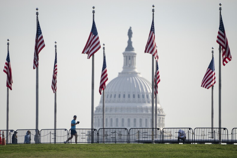 The Capitol is framed by American flags at the Washington Monument.