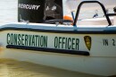 An Indiana DNR conservation officer boat in a body of water