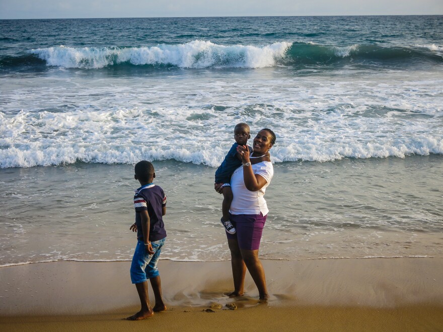 Salimata Sylla, a mother of three, visits Grand Bassam with her family to show she's not afraid of terrorists. On March 13, al-Qaida gunmen killed some 19 people at the beachfront town.