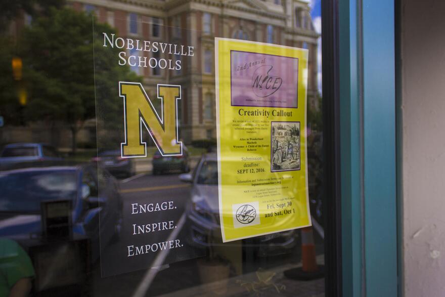 A poster for Noblesville Schools hangs in a coffee shop window. (News File Photo)