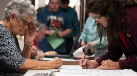 May Morgan signs her name in front of a volunteer before receiving a ballot at the Grady County Election Board in Chickasha on Friday, the second day of early voting. 