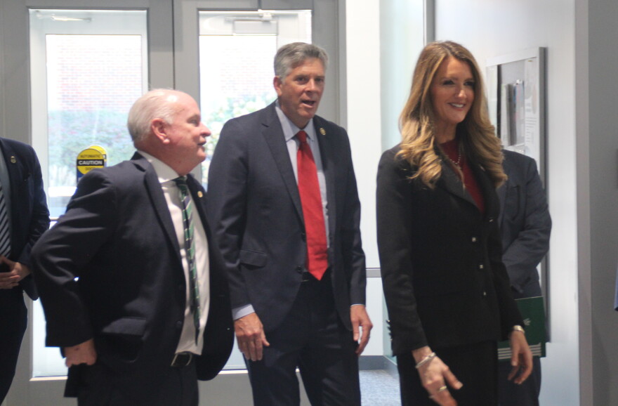 Local and federal officials enter a university building.