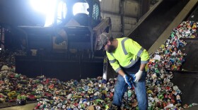 Cyle Hudnell sorts through aluminum cans at the Material Recovery Facility in Columbia