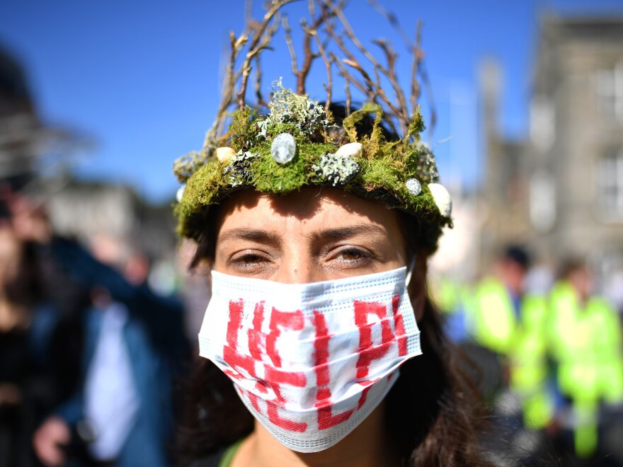 The Global Climate Strike drew scores of protesters around the world Friday, as young people answered a call from activist Greta Thunberg to demand action on climate change. Here, a protester attends a rally in Edinburgh, Scotland.