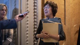 Sen. Susan Collins, R-Maine, chair of the Senate Appropriations Committee, pauses in the door to the chamber to answer a question from a reporter as the Senate works to avert a partial government shutdown ahead of the midnight deadline, at the Capitol in Washington, Friday, March 14, 2025.