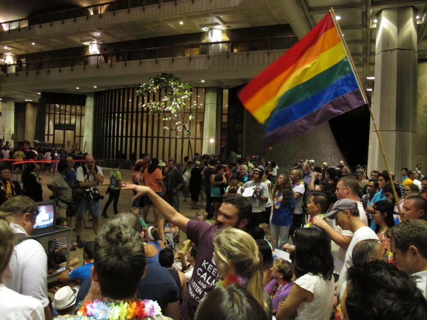 Proponents of gay marriage rally outside House chambers at the Hawaiʻi Capitol in Honolulu on Friday, Nov. 8, 2013. The House debate played out into the night amid noisy crowds outside the chamber and maneuvering inside from lawmakers for and against the bill.