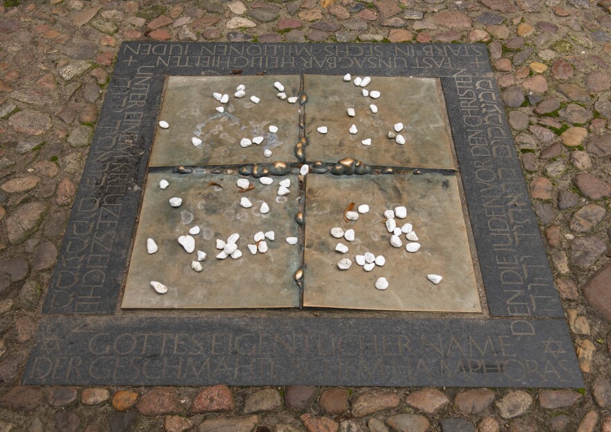 Stones are placed on a Holocaust memorial that was installed on the ground beside the Wittenberg church in 1988.
