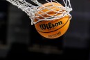 A basketball with a March Madness logo is seen going through a net prior to a second round of the NCAA college basketball tournament between Notre Dame and Michigan, March 23, 2025, in South Bend, Ind.