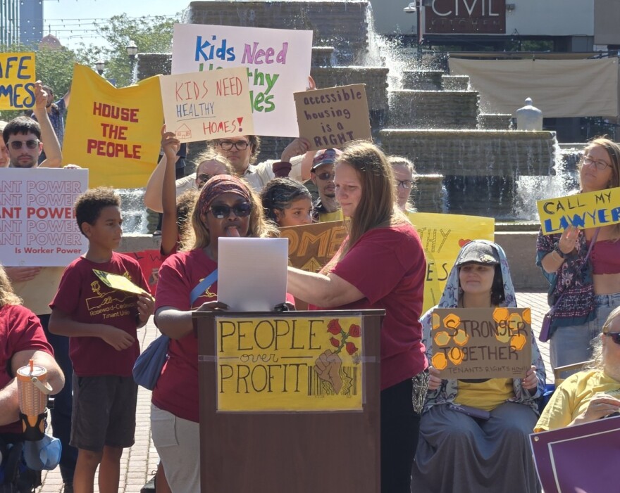 Shellastine Williams with the Rosewood-Cedarwood Tenants Union addresses the crowd, surrounded by members of the union and supporters.