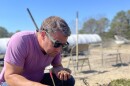 Chris Trump inspects a fermentation pile in Truro built by students at his week-long Korean Natural Farming Class.