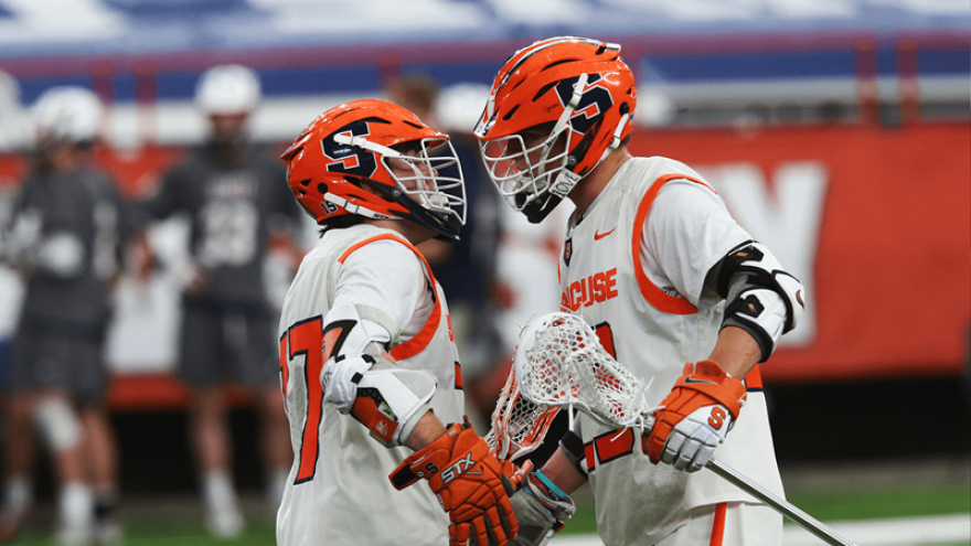 Jakob Phaup (left) and Tucker Dordevic (right) embrace following a Syracuse goal.