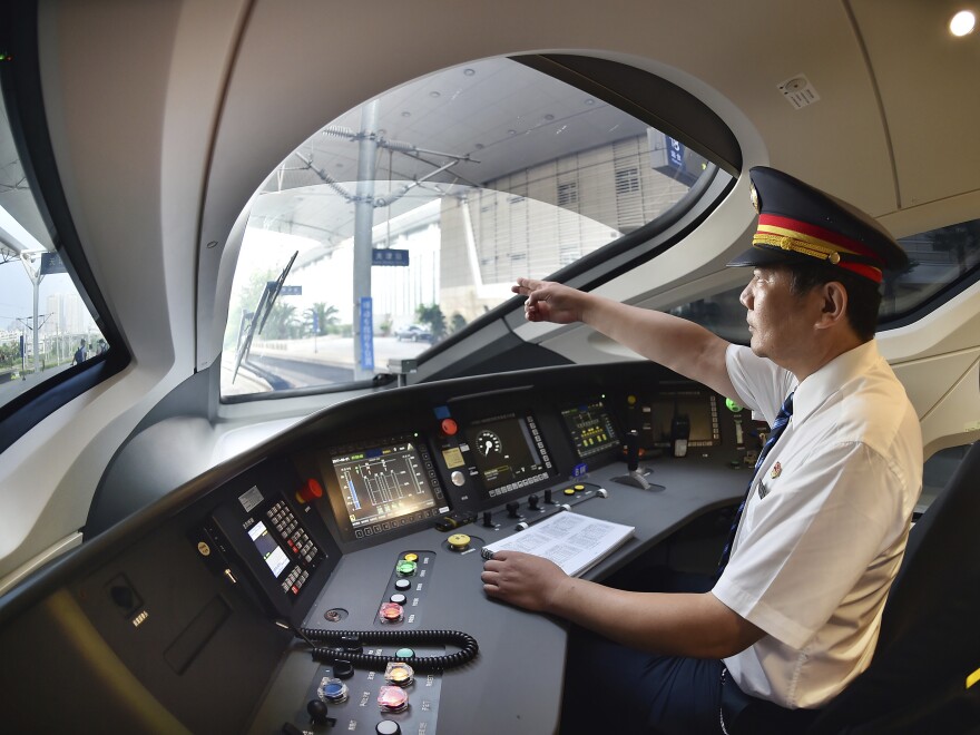 A train driver prepares to operate the Fuxing bullet train as it travels from Tianjin to Beijing.