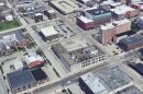 An aerial view of the former Pantagraph building in Downtown Bloomington, with the parking lot just to its north.