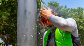 Beachgoer Sergei lazovskiy cools off under the shower after enjoying the sunny and hot day at the Haulover Park Beach at on Tuesday, May 28, 2024, in Miami Beach, Florida.