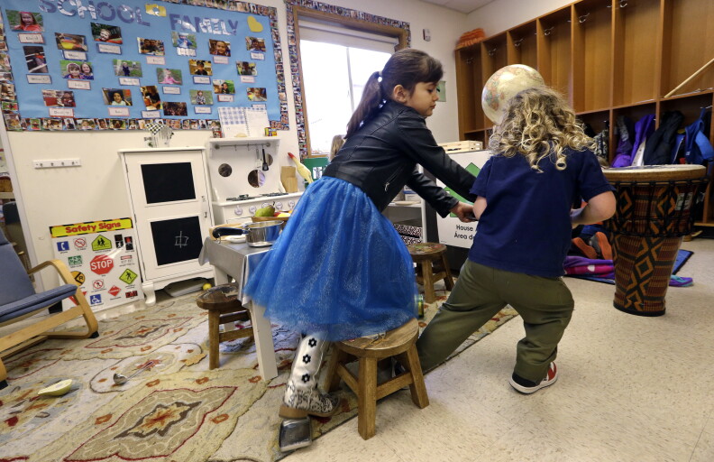 In this photo taken Friday, Feb. 12, 2016, Nuray Bolat, left, and Ocean Epling briefly tussle over a toy at the Creative Kids Learning Center, a school that focuses on pre-kindergarten for 4- and 5-year-olds, in Seattle. While the states early learning program gets kudos for its efforts to improve quality, it gets poor marks for the small number of kids who are benefiting from high quality preschools. The state now publishes useful information online that could help parents figure out where to send their children for preschool, but most of that data is hard to find and decipher. (AP Photo/Elaine Thompson)