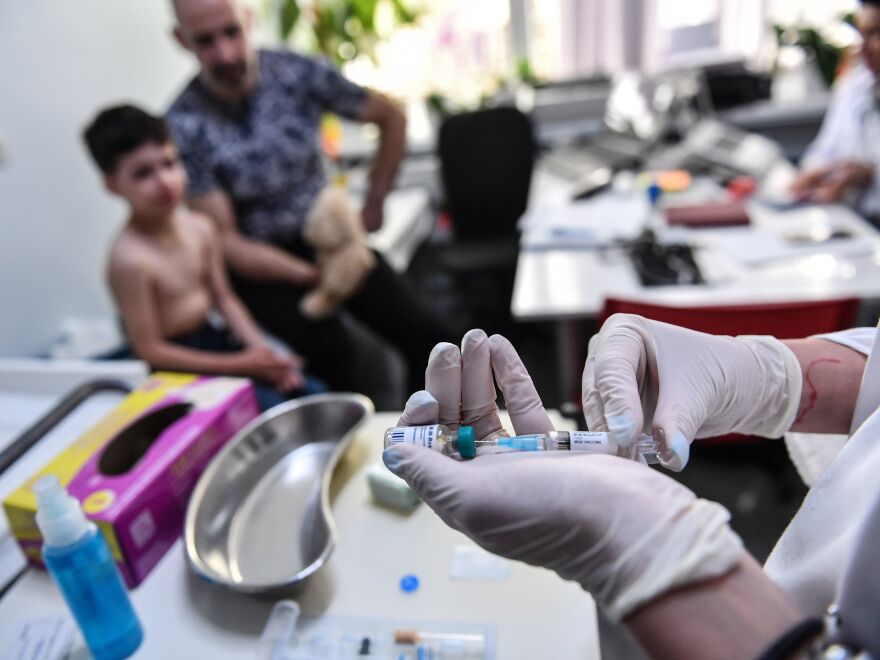 Measles cases have spiked globally after years of decline. Here, a family physician prepares a measles vaccine in Bucharest, Romania. Doctors there say that parental hesitancy about vaccines and lack of faith in state institutions have hurt immunization efforts. [Daniel Mihailescu/AFP / Getty Images]