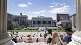 Students sunbathe on the steps of Columbia University's Low Memorial Library, April 29, 2015 in New York. (AP Photo/Mark Lennihan)