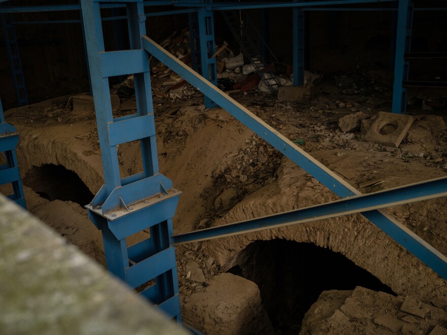 Scaffolding is attached to 6th century archways surrounded by garbage.