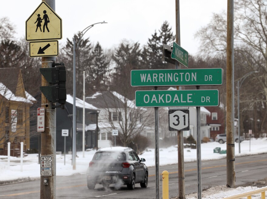 Traffic moves along Monroe Avenue in Brighton, N.Y. Crosswalks like this one at Warrington Road and Monroe Avenue have been identified for improvements as part of a state Department of Transportation proposal to resurface and reconfigure much of the corridor, add safety features, and potentially lower the speed limit for drivers, pedestrians and cyclists.