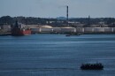 A ferry crosses Havana Bay past the Nico Lopez oil refinery 