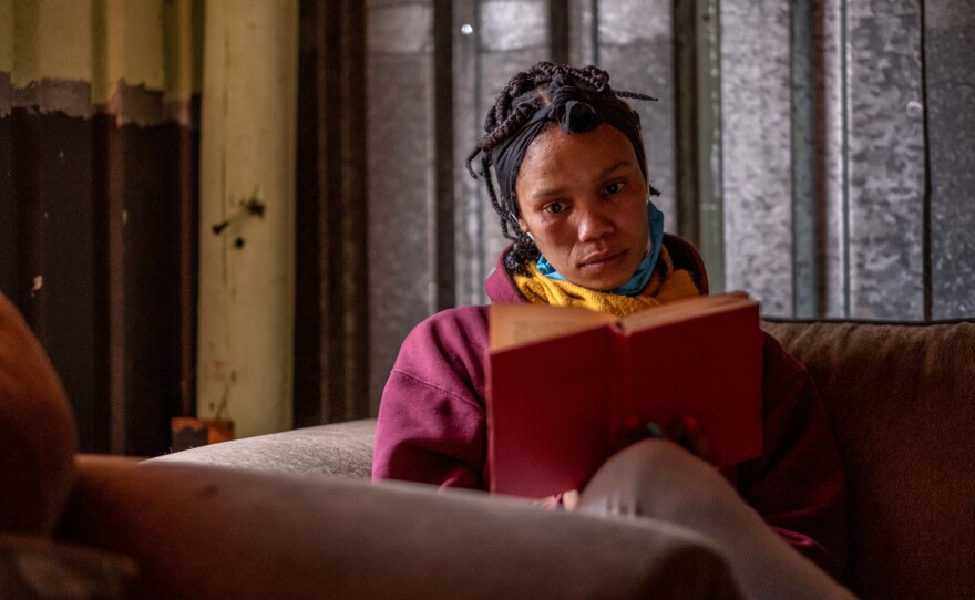 Librarian Abigail Cloete reads Ena Murray's <em>Heartbeat in Hawaii. </em>"I like to feel the emotions," she says. "I like reading books that make me cry."
