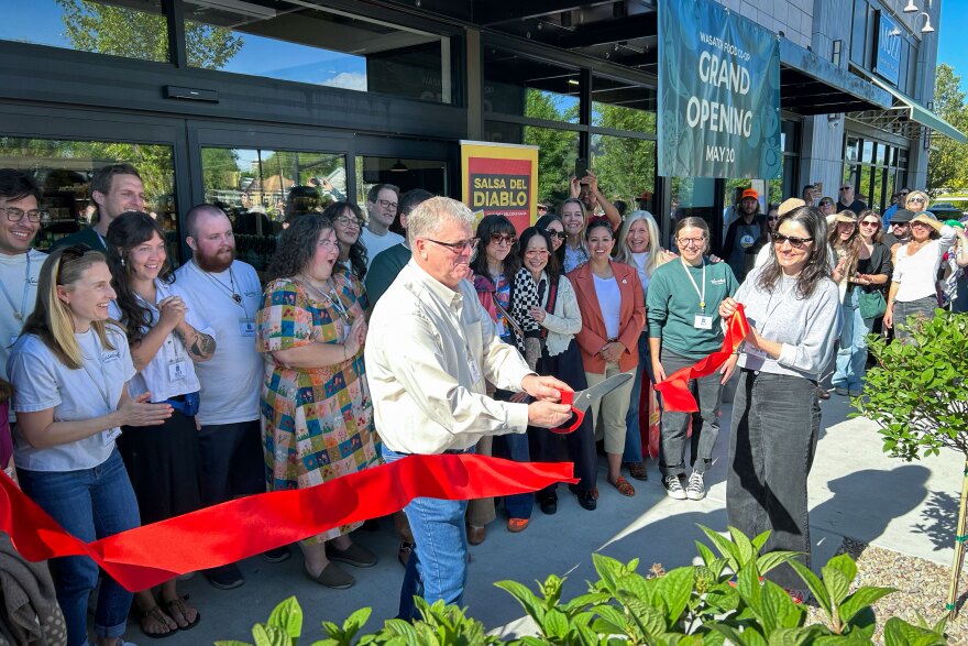 Wasatch Food Co-op interim general manager Garland McQueen cuts the ceremonial ribbon to declare the store officially open for business, May 20, 2026.