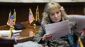 State Superintendent Glenda Ritz reads through a report drafted by her colleagues on the 2015 Blue Ribbon Commission.