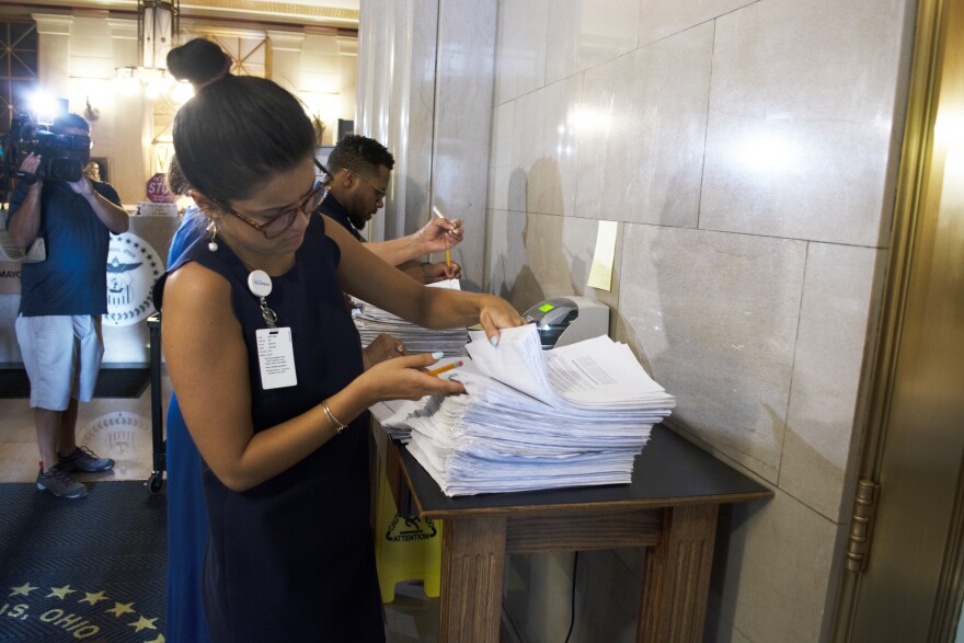 Anti-ticket tax petition signatures are counted at City Hall.