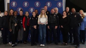 Mary Johns, a student at the University of Florida, receives the Police Service Award on Jan. 27, 2026, from employees of the UF campus police department for her help identifying a suspect in a series of sexual assaults near the campus. (UF Police Department/WUFT News)