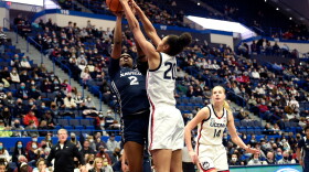 Xavier Musketeers center Mikayla Hayes #2 is smothered by UConn Huskies forward Olivia Nelson-Ododa #20 during their game at the XL Center in Hartford Connecticut January 15, 2022.