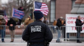 A Capitol Police officer watches supporters of U.S. President Donald Trump gather outside the U.S. Capitol on January 6, 2021 in Washington, DC. (Cheriss May/Getty Images)