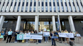 A large crowd of advocates stand behind Deputy Erie County Executive Lisa Chimera as she speaks at the Flag of Hope flag raising in front of the Rath Building in Buffalo, New York, on Friday, September 18, 2026.