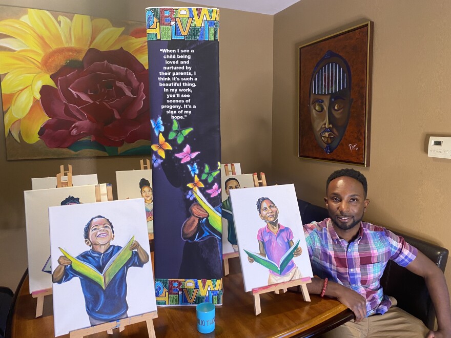 Jamil Dyair Steele, who grew up in west Charlotte, near his paintings that will reflect the corridor’s history.