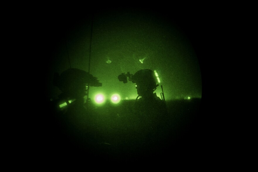 Members of the United States Army Special Forces, also known as the Green Berets, look through night vision goggles during a training of Afghanistan Special Forces on Sept. 10, in Helmand province, Afghanistan.