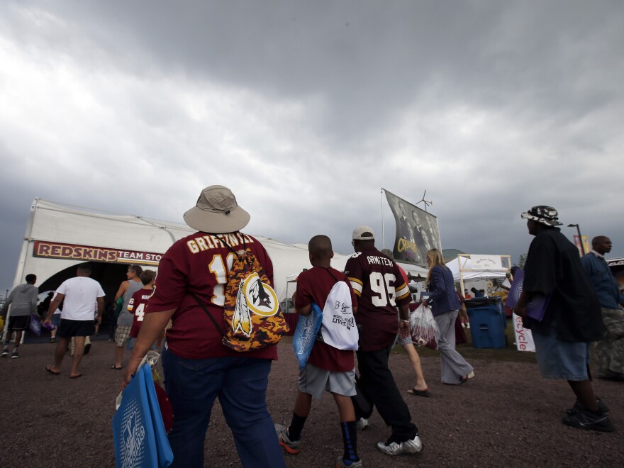 Fans leave the Washington team's training facility after rain forced the cancellation of the team's outdoor practice in Richmond, Va.